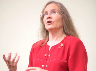Nancy is speaking while making gestures with her hands