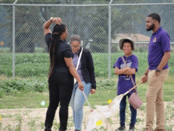 FAMU students work in a field with nets